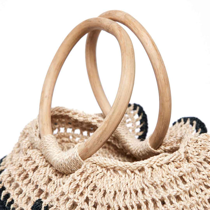 Detail of ripple basket natural cane handles.
