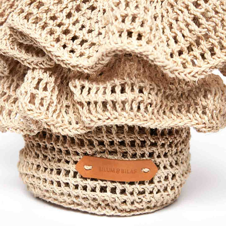 Detail of woven basket with natural fibre ruffles.