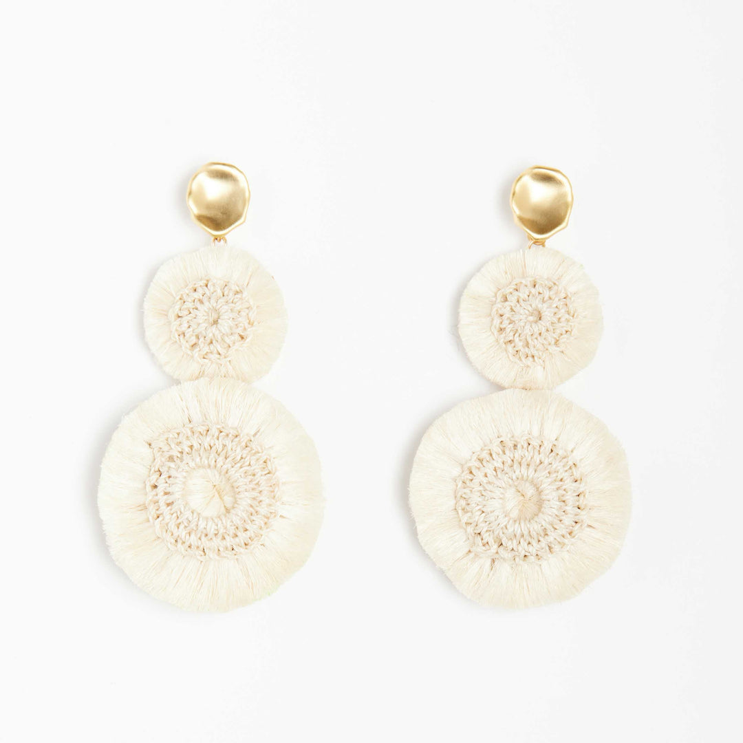 Natural fibre pom pom earrings on white background