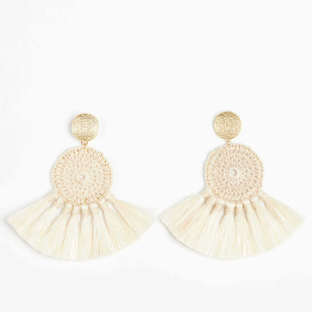 Woven disc earrings with fringing and gold disc on white background.