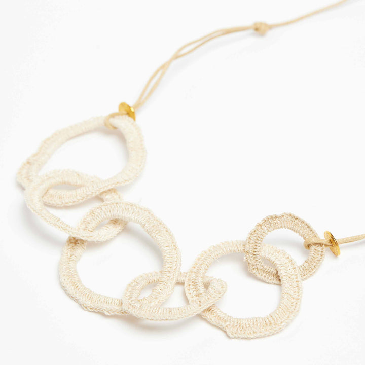 Woven chain necklace on a side angle.