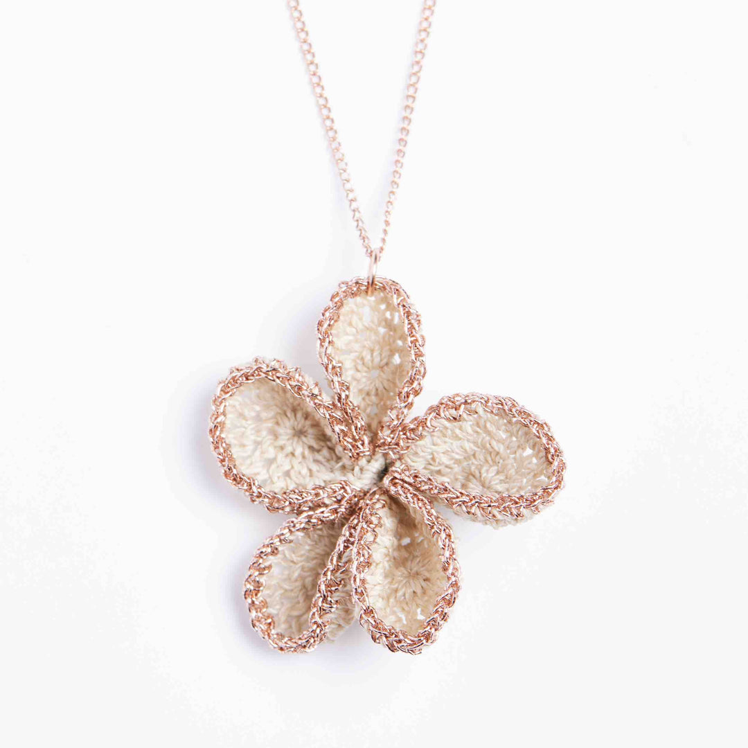 Close up on rose gold metallic and natural flower pendant #Rose Gold