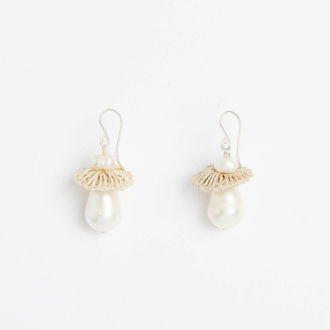 Front view of silver pearl drop earrings with woven natural fibre disc