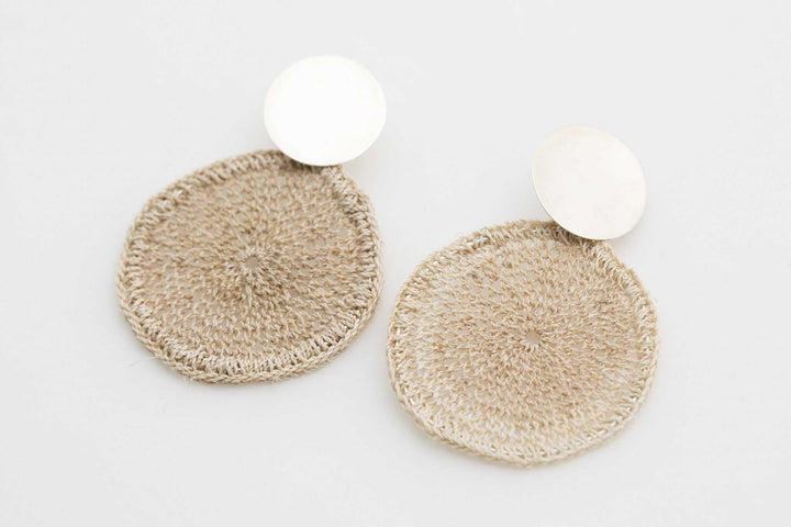 Side angle of Bilum and Bilas handwoven natural fibre and sterling silver disc earrings