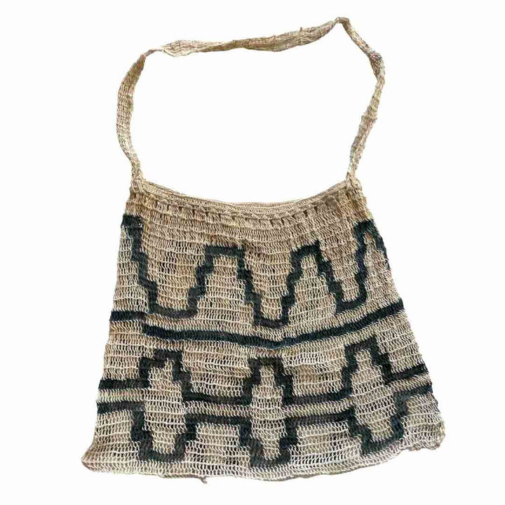 Flat lay of dark green and white patterned string bilum from Umboldi Village in PNG.
